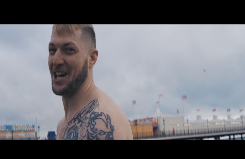 A photographic still from the short film Run Deep. The photo shows a man smiling at the camera.